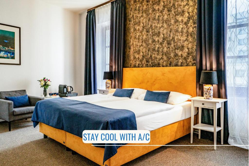 a hotel room with a bed with a blue blanket at BlueBell Hotel in Bratislava