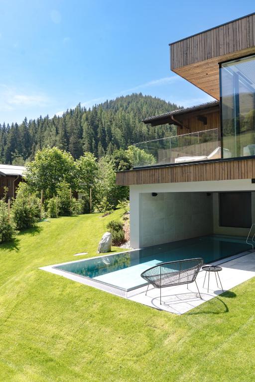 a house with a swimming pool in the yard at Haus Jausern in Saalbach-Hinterglemm