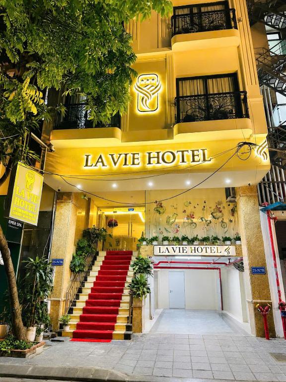 a hotel with a red staircase in front of a building at Lavie Hotel in Hanoi