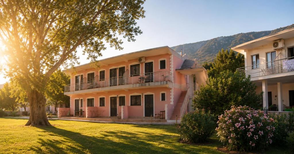 a large house with a tree in front of it at Hotel LULI in Baks-Rrjoll
