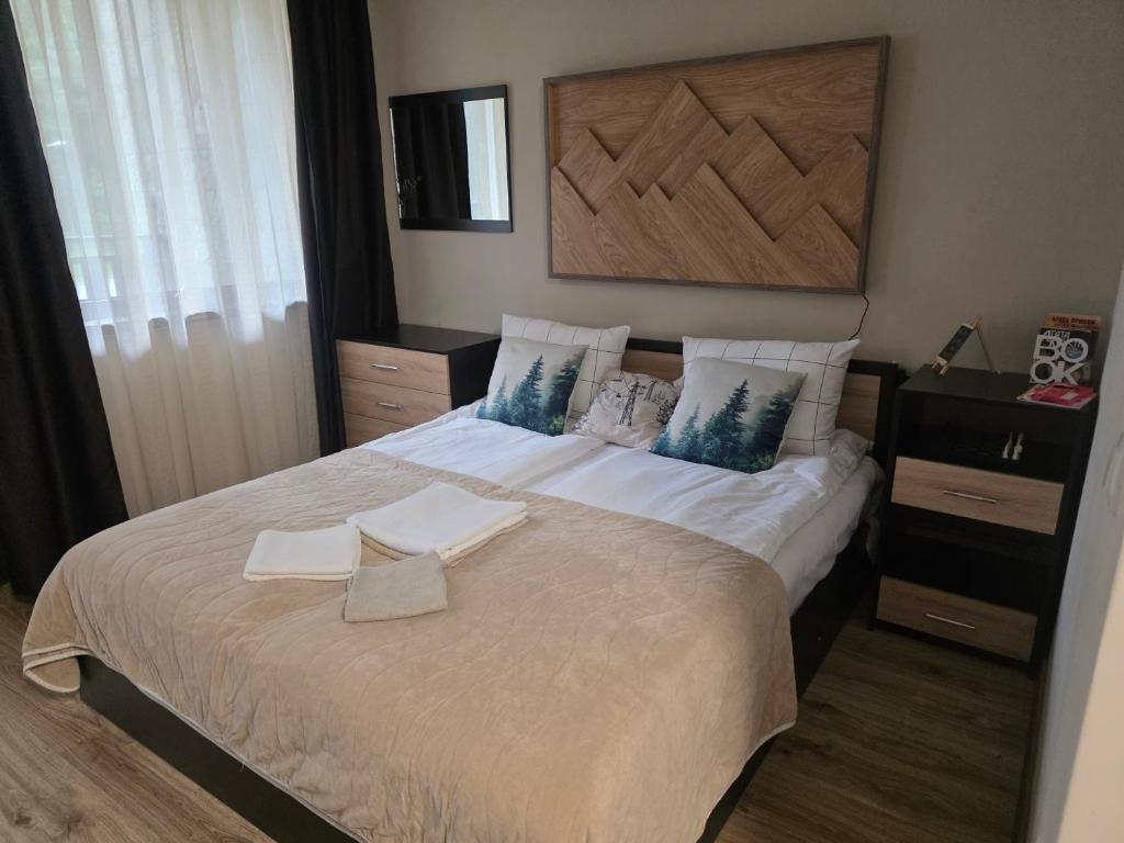 a bedroom with a bed with two towels on it at Borovets Gardens Studio Raya in Borovets