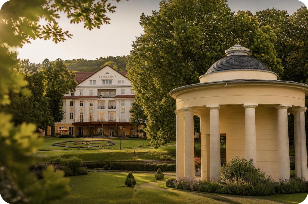 a building with a gazebo in the middle of a garden at Kulturhotel Kaiserhof in Bad Liebenstein