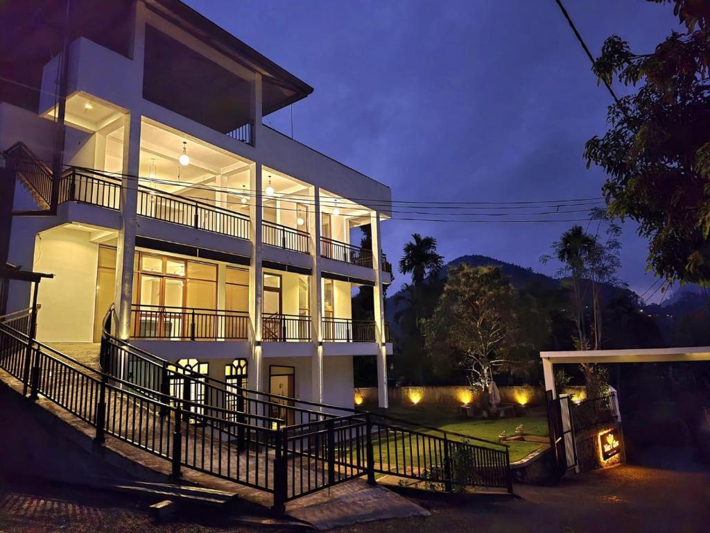 a large white building with a lot of windows at Ella, Nine Glow Resort in Ella