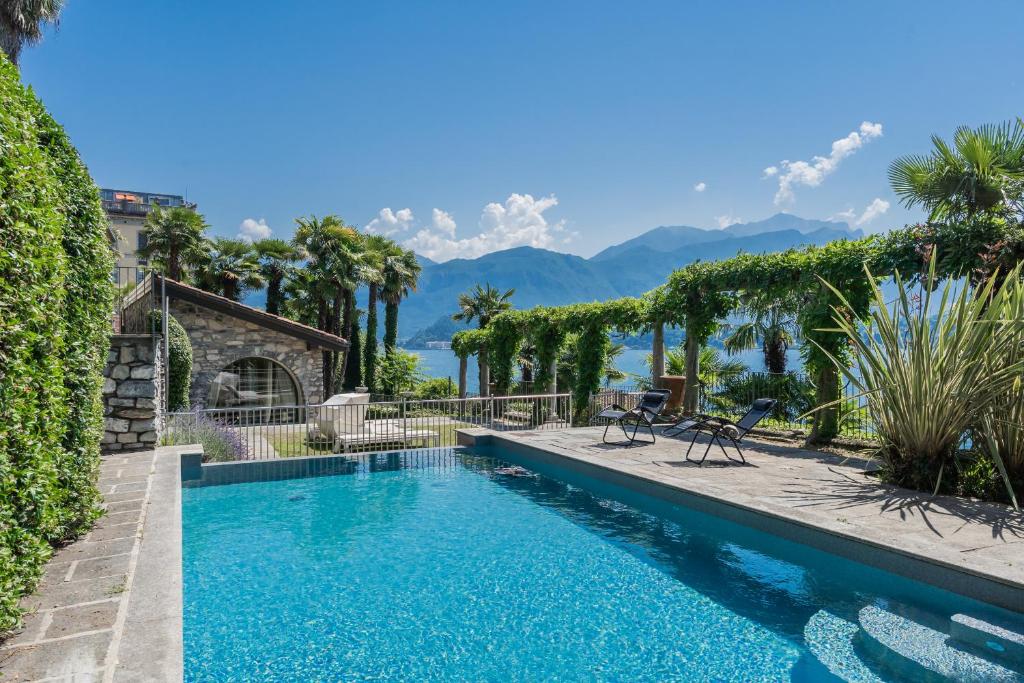 a swimming pool with a view of the mountains at Luxury Villa in Tremezzo con piscina in Tremezzo