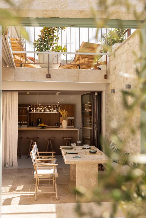 a kitchen and dining room with a table and chairs at Stone House Orsera II in Vrsar