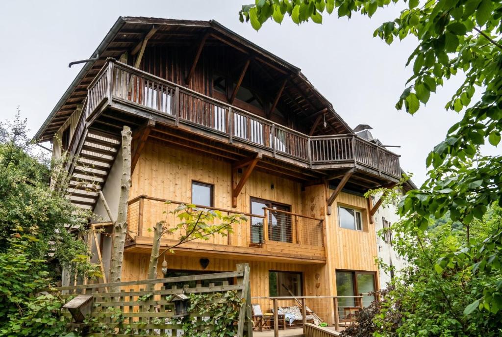 a large wooden house with a gambrel roof at Top Floor Chalet Apartment in Saint-Jean-d'Aulps, Balcony in Saint-Jean-d'Aulps