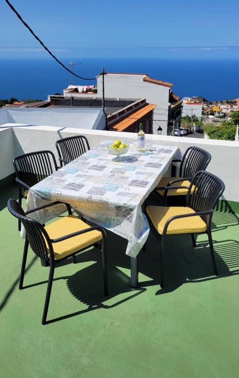 a table and chairs sitting on a roof at Casa Gustavo Apartman in La Guancha