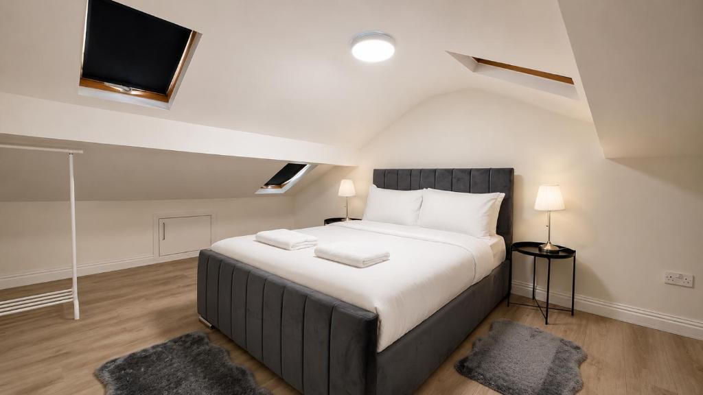 a bedroom with a large bed with two pillows at Cosy Flat on the Top Floor in Ramsbottom in Ramsbottom