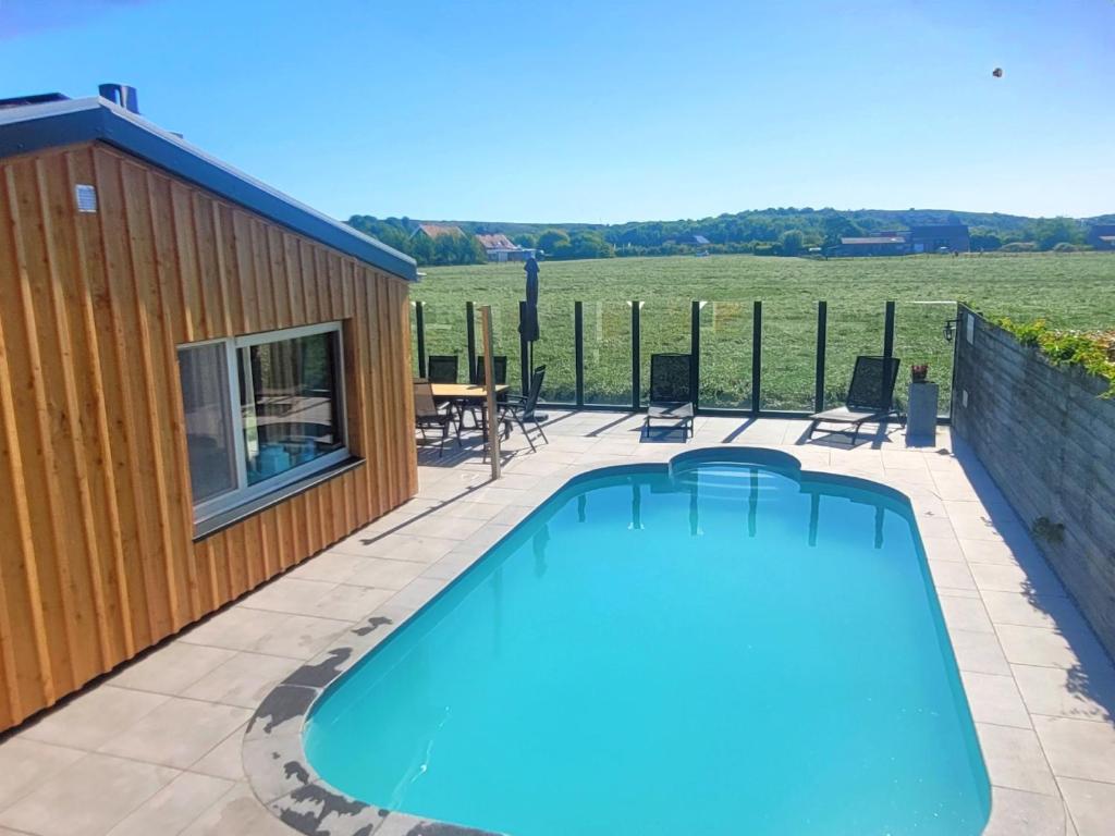 a swimming pool on a patio next to a building at Zoet & Zout in Zoutelande