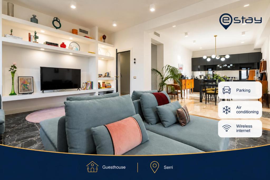 a living room with a blue couch and a tv at Estay - Biora Hospitality in Serri