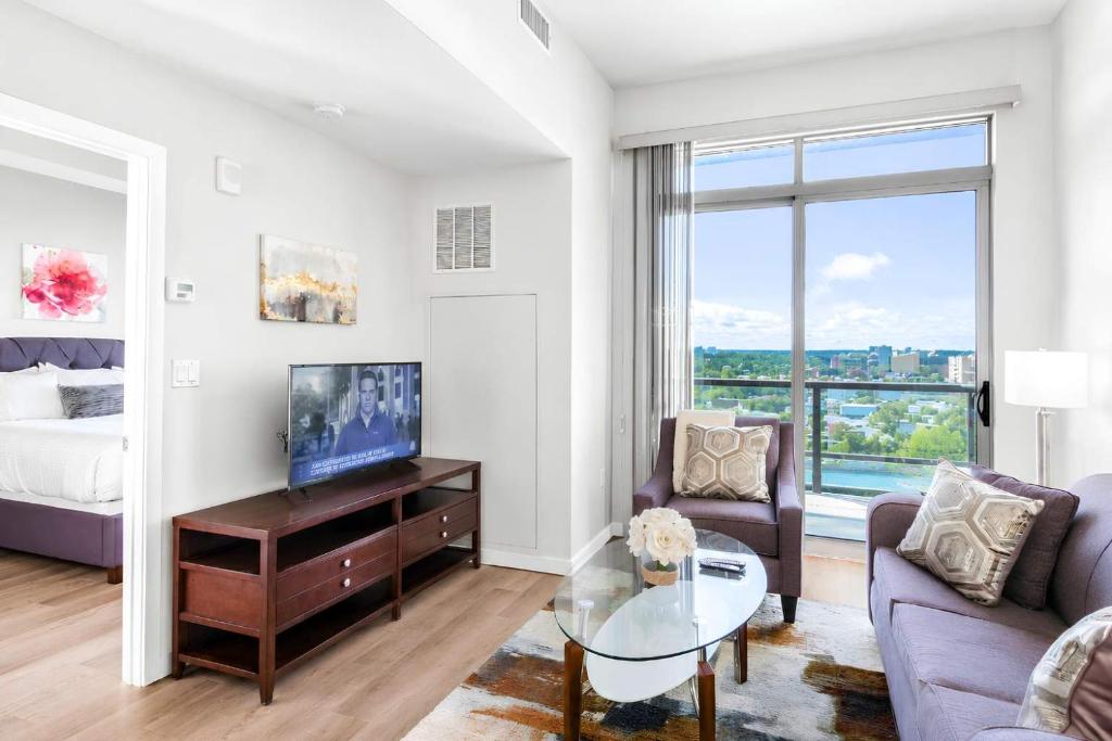a living room with a couch and a tv at Luxury Apartment In Harbor Point in Stamford