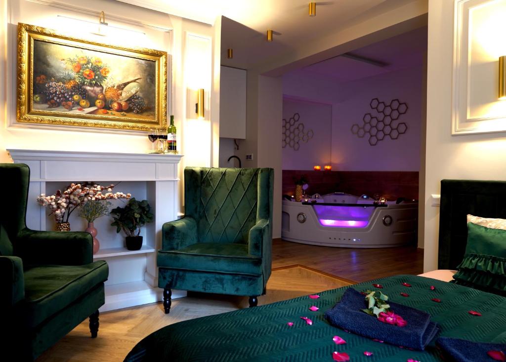 a living room with a bed and a tub at Jacuzzi Przemyska in Krakow