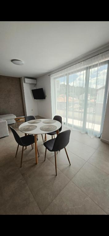 a living room with a table and chairs and a couch at CIty view apartment in Gotse Delchev