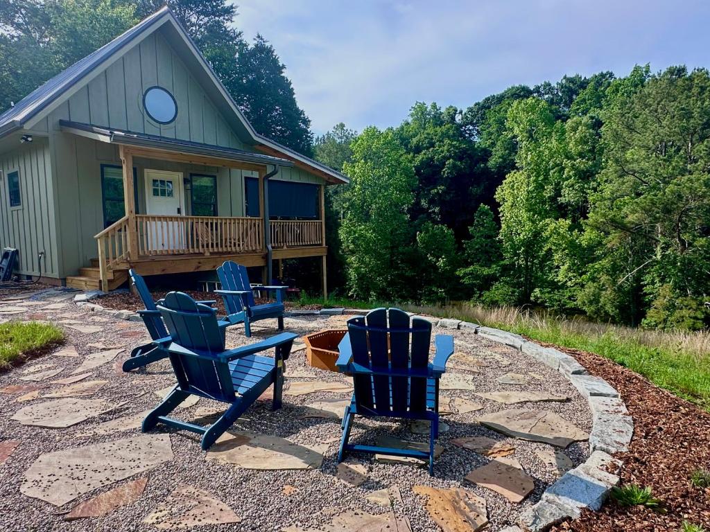 three blue chairs sitting on a patio in front of a house at By the Docks Knox in Knoxville