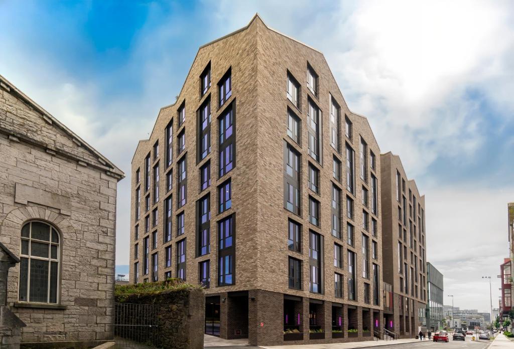 a tall brick building with a triangular top at Queen Street Place in Galway