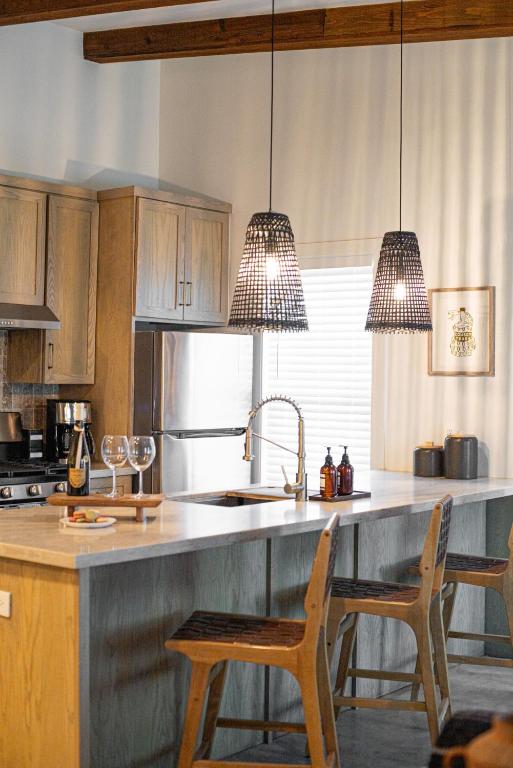 a kitchen with wooden cabinets and a kitchen island with chairs at Orion A 3BR Heated Pool with Desk and Laundry in Port Isabel