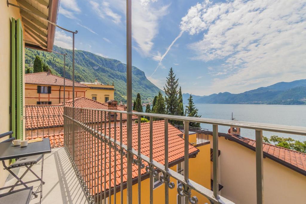 a balcony with a view of a lake and mountains at La Corte del Lario - La Cortesella in Varenna