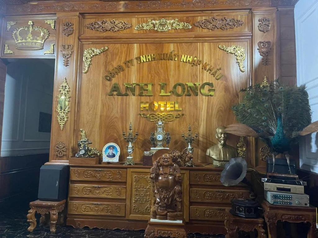 a room with a dresser with a sign on it at Hottel ANH LONG in Buôn Ðũng
