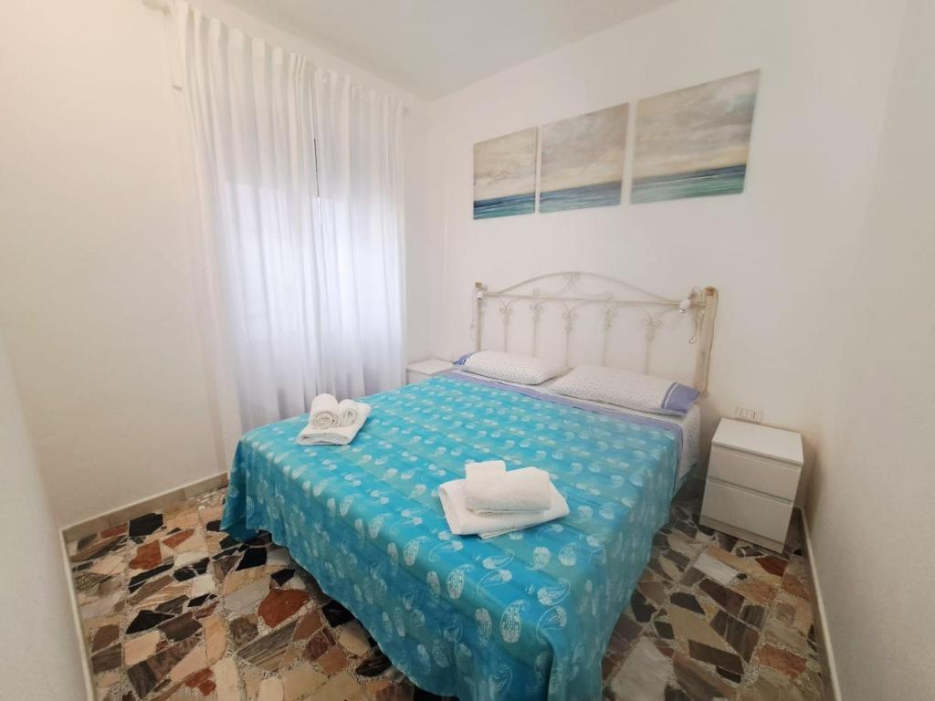 a bedroom with a bed with towels on it at S'erribera de S'abiolu in Baunei