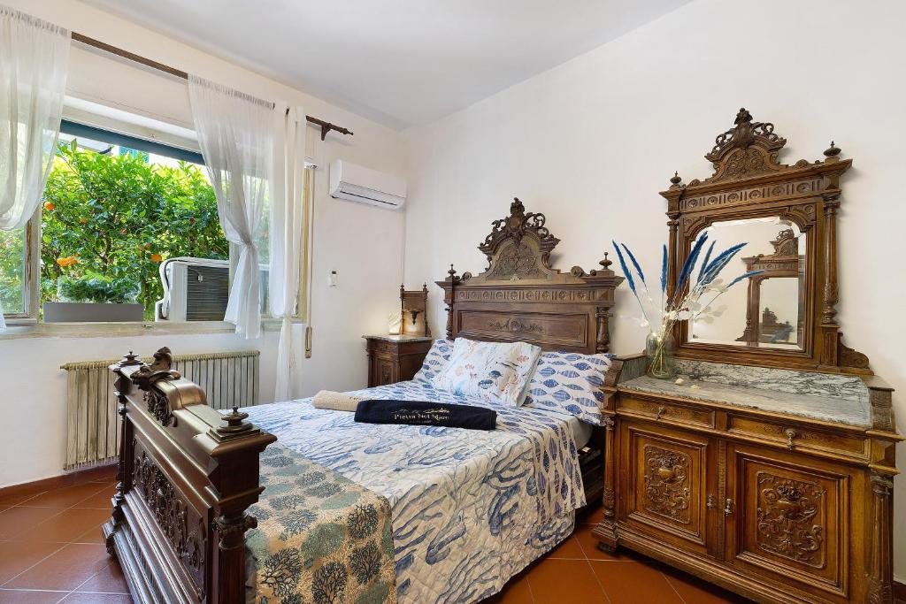 a bedroom with a bed and a large mirror at Pietra nel mare in Pietra Ligure