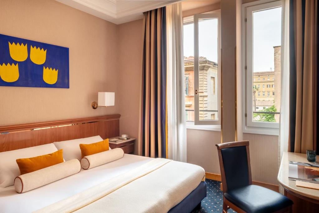 a hotel room with a bed and a window at Hotel Diocleziano in Rome