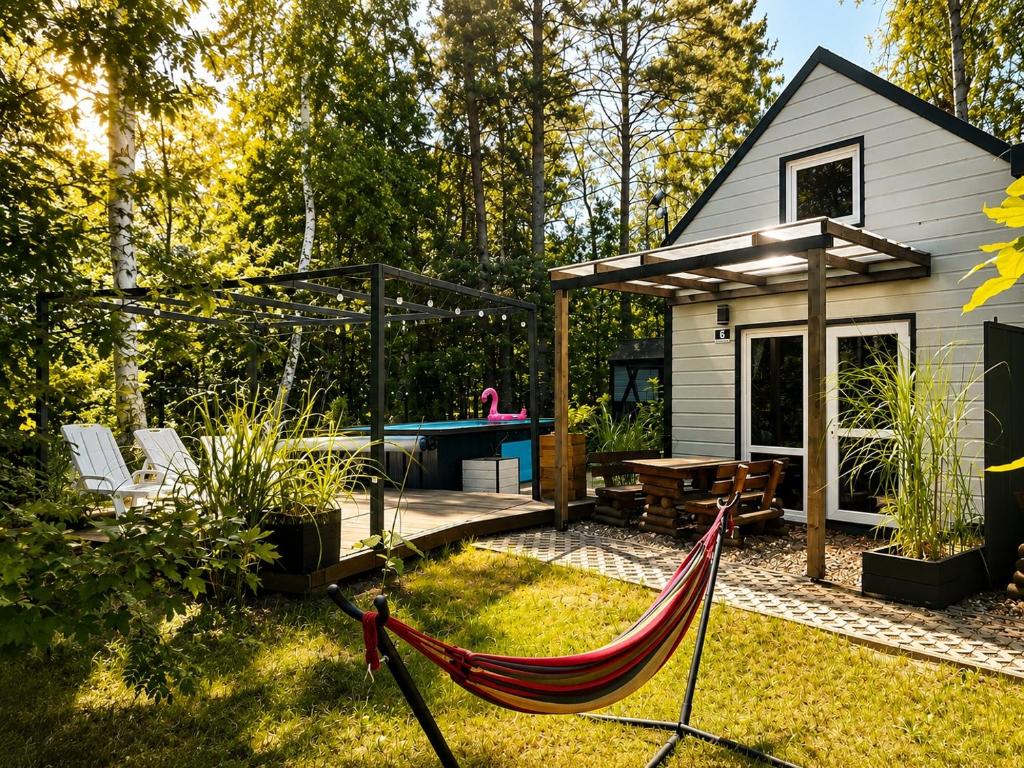 a backyard with a hammock and a house at Family Resort in Dziwnów