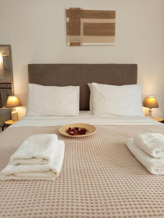 a bed with a plate of food on top of it at Feidiou 1, vol I in Egina