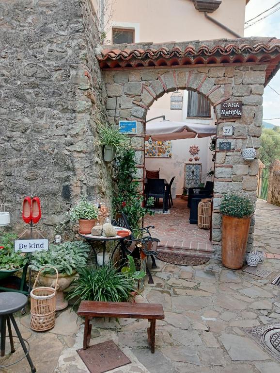 a stone building with a patio with a table and chairs at Casa Marina, casa Vacanza, Suite Indipendente Cilento in Ceraso
