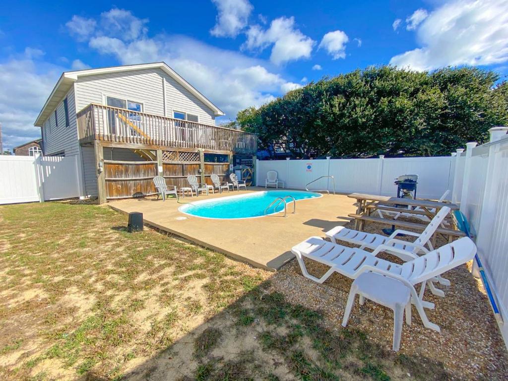 a backyard with a swimming pool and a house at 4125 - Sea Dawg in Kitty Hawk