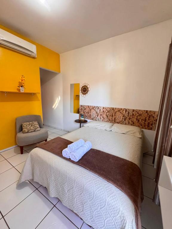 a bedroom with a bed with two towels on it at Bru&Mar Pousada in Parnaíba