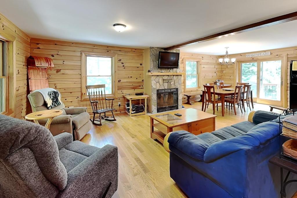 a living room with a blue couch and a fireplace at Crazy Idea in Swanton