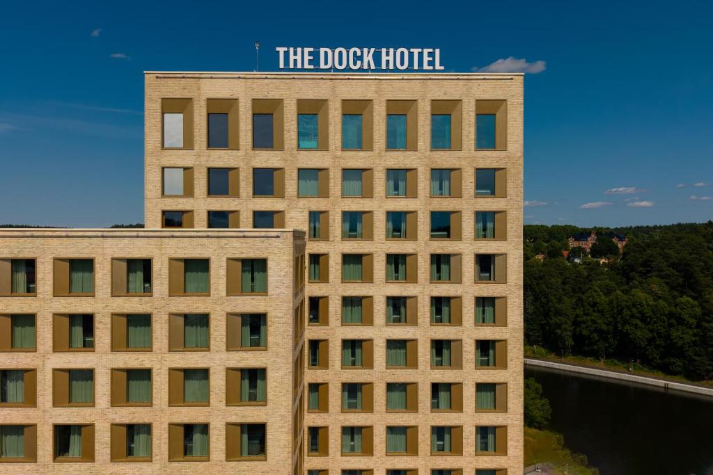 a building with a sign on the top of it at The Dock in Södertälje