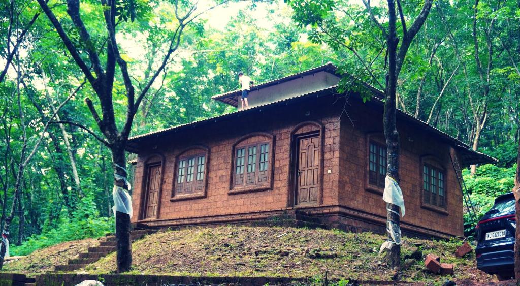 a small house with a bird on top of it at Villa Terra, Spacious 2BR Villa in Kannur