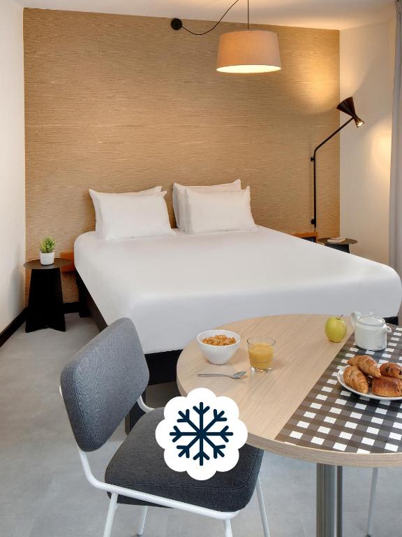 מיטה או מיטות בחדר ב-Résidence Callou by Vy Resort Thermal & Spa