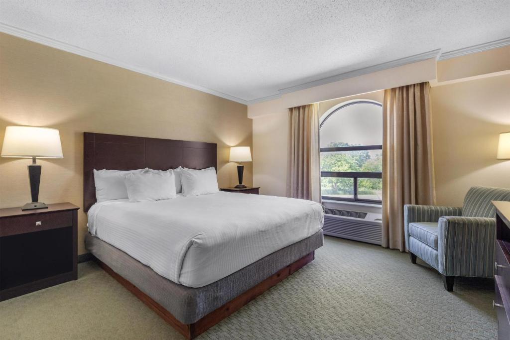 a hotel room with a bed and a window at Best Western Davison Inn in Davison