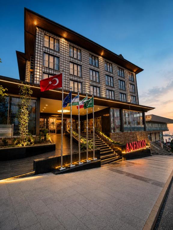 a large building with flags in front of it at Anemon Kent Trabzon Otel in Trabzon