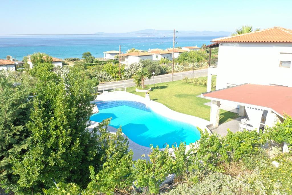 an overhead view of a swimming pool with the ocean in the background at Nautica Villa in Hanioti