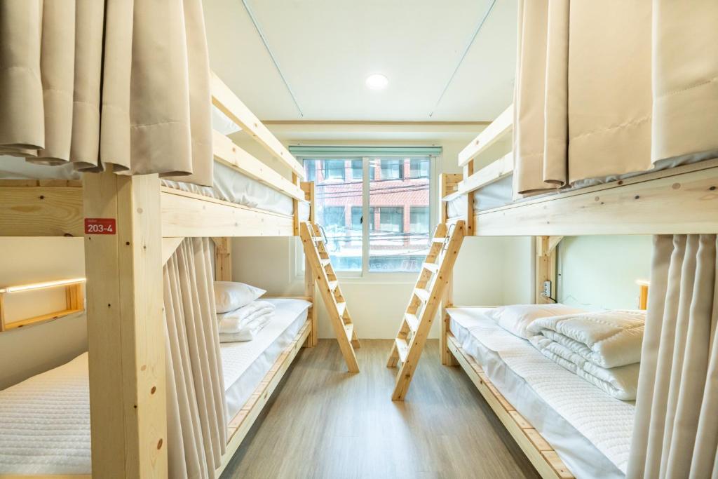 a room with two bunk beds in a hostel at Visitor guesthouse in Jeju