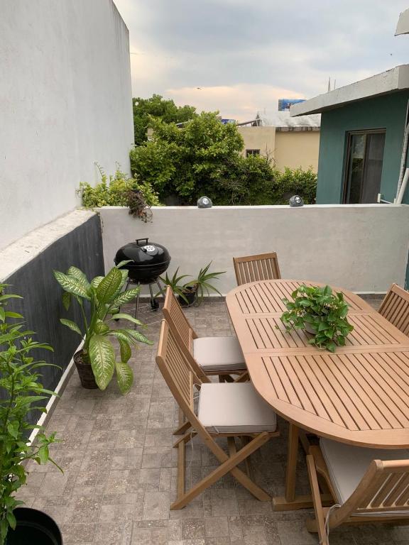 a patio with a table and chairs and a grill at La Pastora in Monterrey