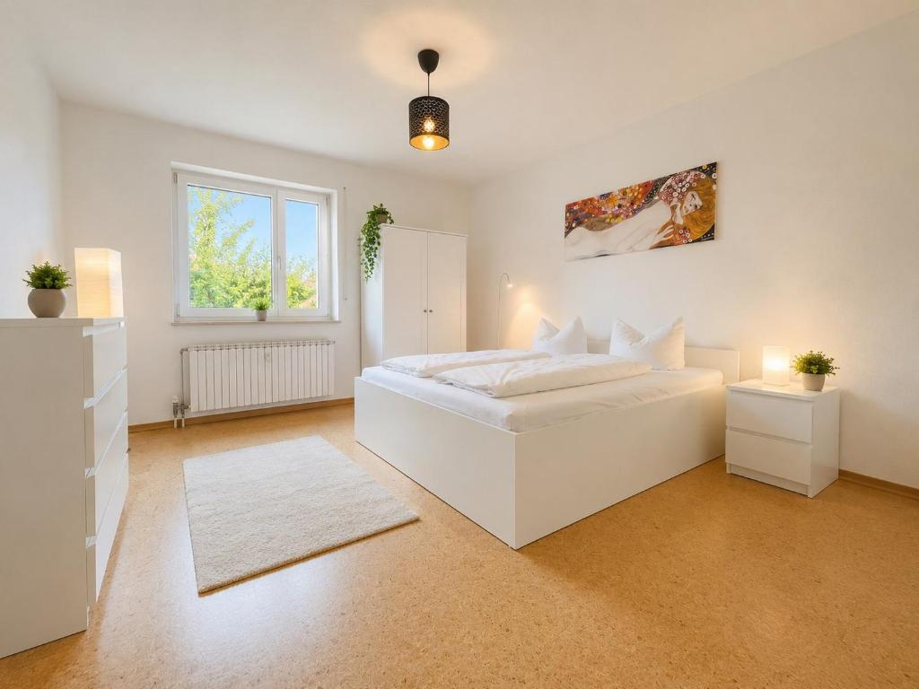 a white bedroom with a white bed and a window at Dill Apartments Pleinfeld Pacellistraße in Pleinfeld
