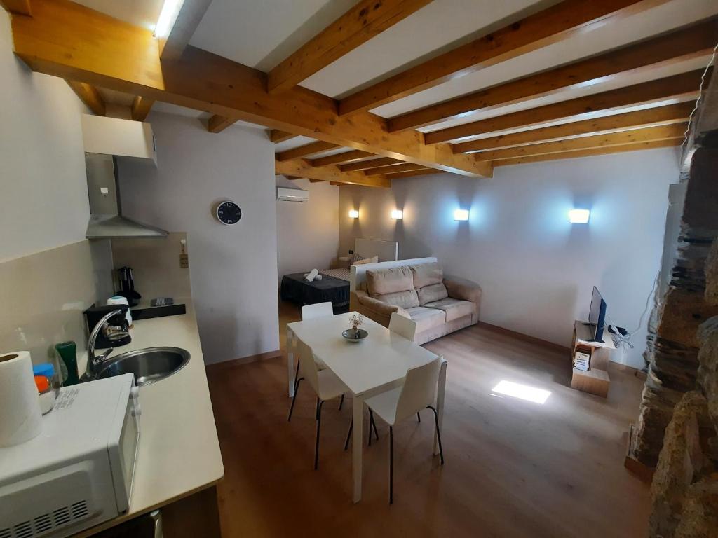 a kitchen and living room with a table and a couch at Muelle Real in Mugardos