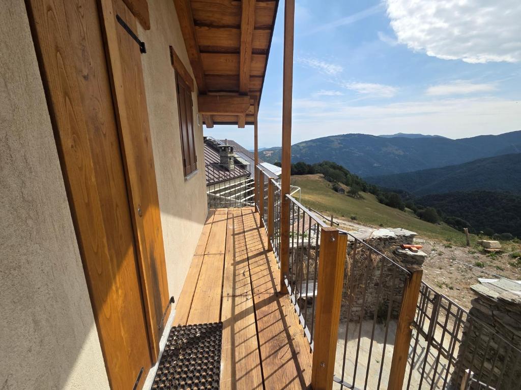 a balcony of a house with a view of the mountains at Chalet Burrino in Frabosa Soprana