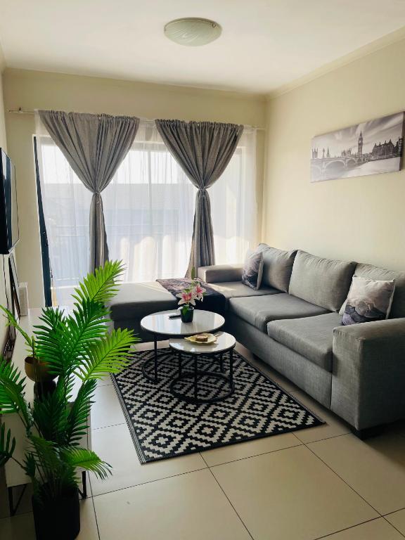 a living room with a couch and a table at Cozy getaway in Midrand
