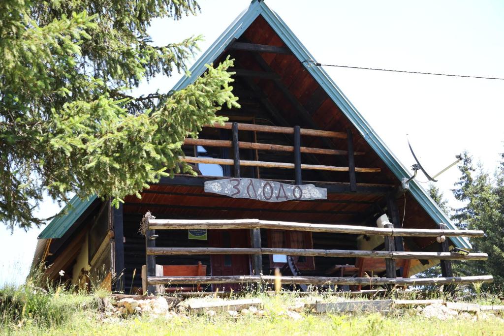 a log house with graffiti on the side of it at Forest Cabin Ponikve in Čajniče