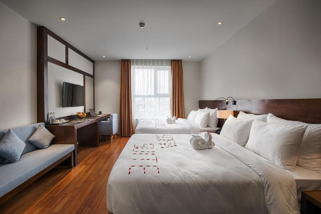 Rúm í herbergi á Sofia Suite Hotel Danang