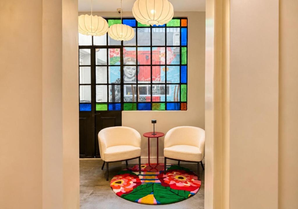 a room with two chairs and a table and a stained glass window at Los Patios de Julia by DOT Boutique in Buenos Aires