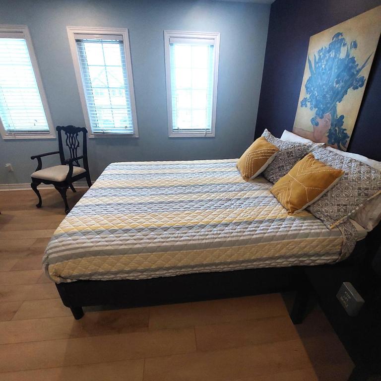 a bedroom with a bed with yellow pillows on it at Nimo Homestay in Guelph
