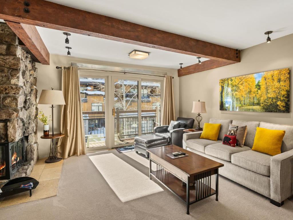 a living room with a couch and a fireplace at Lift One Condominiums - Unit 409 in Aspen