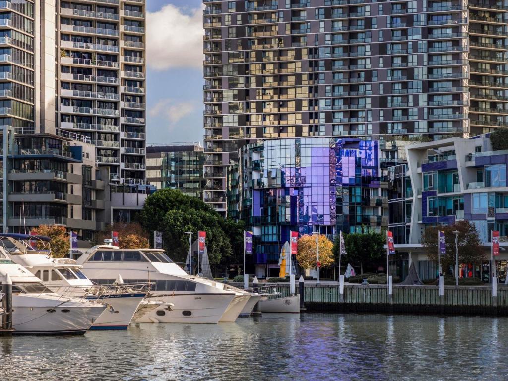 a group of boats docked in a harbor with tall buildings at The Sebel Melbourne Docklands Hotel in Melbourne