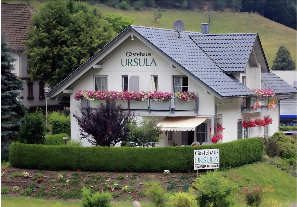 a white building with a sign in front of it at Gästehaus Ursula in Hornberg